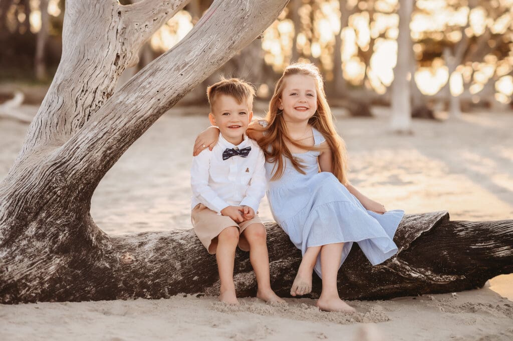 Siblings pose for Family Portraits on Folly Beach, South Carolina.