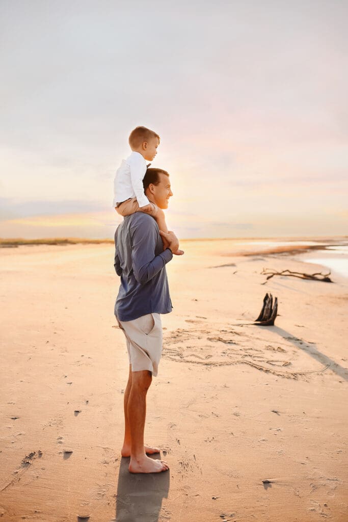 Father carries his young son on his shoulders during Family Photoshoot on Folly Beach, South Carolina after searching Parents embrace their children during Family Photoshoot on Folly Beach, South Carolina after reading about the Best Things to Do on Folly Beach with Kids.