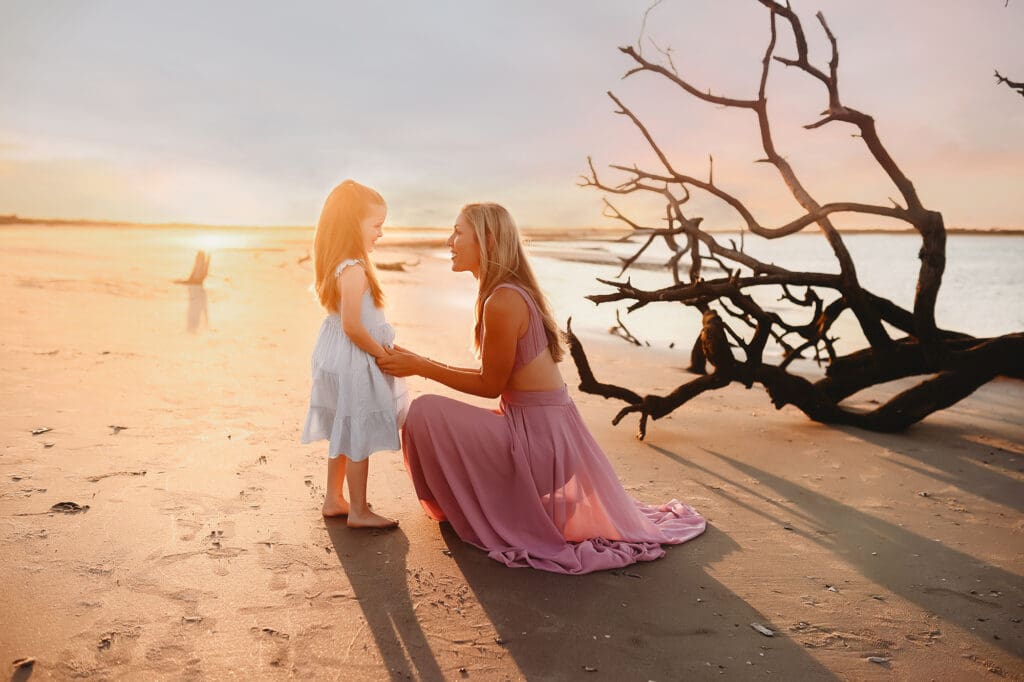 Mother chats with her young daughter during Family Portraits on Folly Beach.
