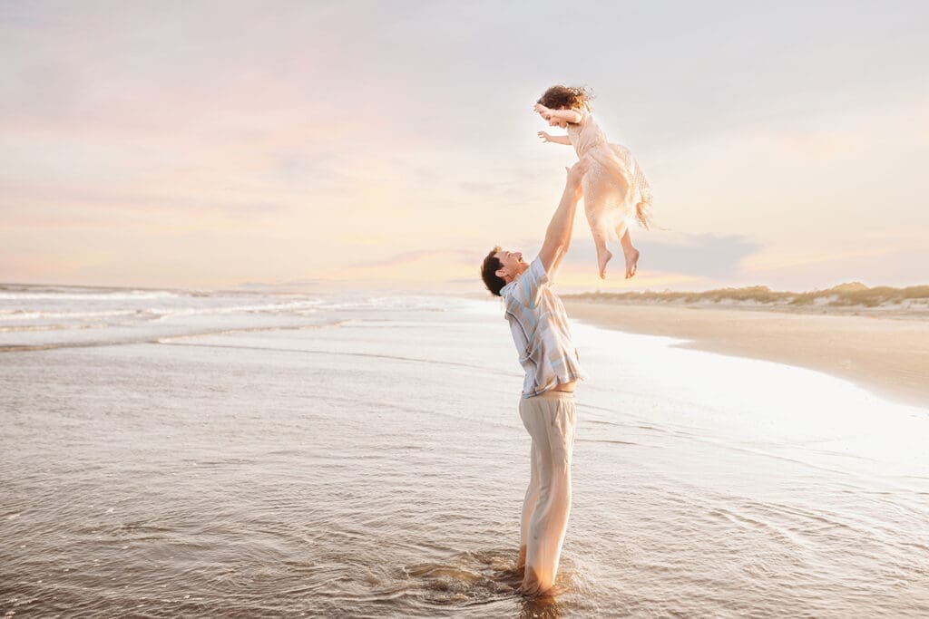 Father plays with his daughter during Family Pictures on Kiawah Island with Holy City Family Photography.