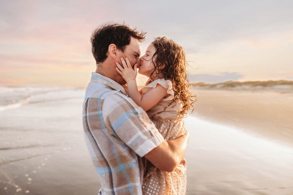 Little girl kisses her father during Family Photoshoot on Kiawah Island with Holy City Family Photography.