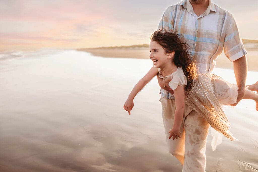 Father plays with his daughter during Family Portrait Session on Kiawah Island with Holy City Family Photography.