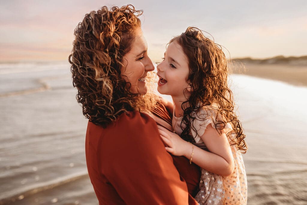 Mother embraces her daughter during Family Portrait Session on Kiawah Island with Holy City Family Photography.