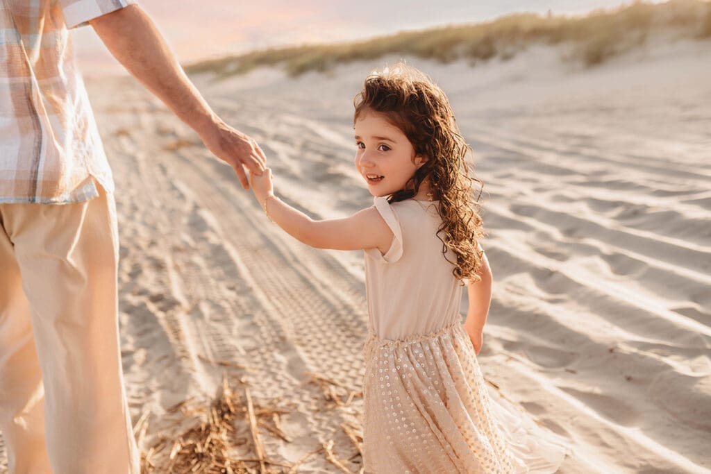 Father walks along the beach with his daughter during Family Portrait Session on Kiawah Island with Holy City Family Photography.
