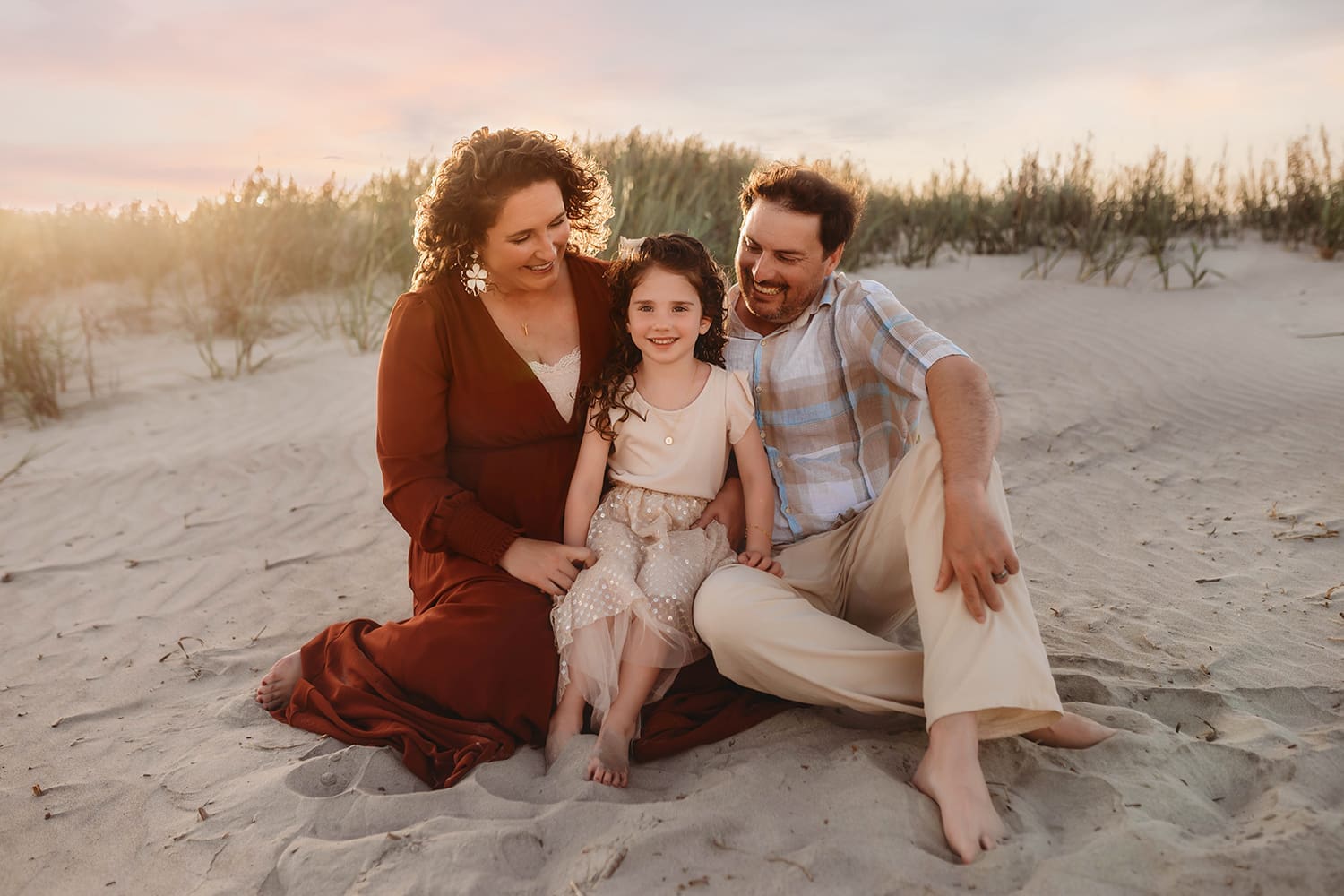 Family sits together on the beach during Family Photoshoot on Kiawah Island.