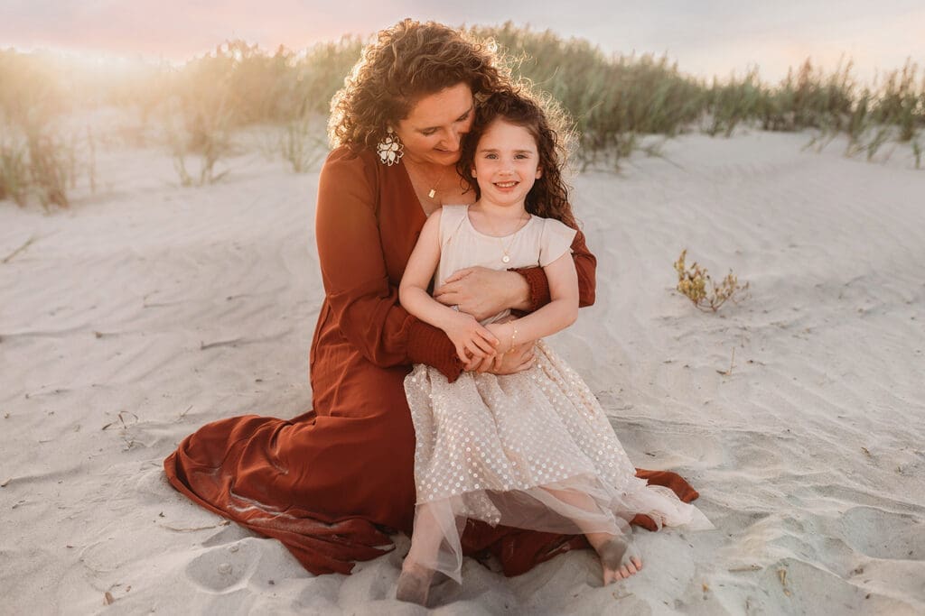 Mother embraces her daughter during Family Portraits on Kiawah Island with Holy City Family Photography.