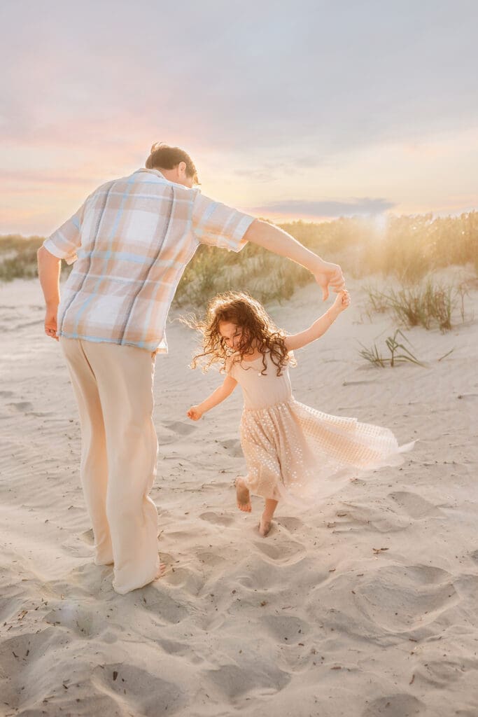 Father dances with his daughter during Family Portrait Session on Kiawah Island with Holy City Family Photography.