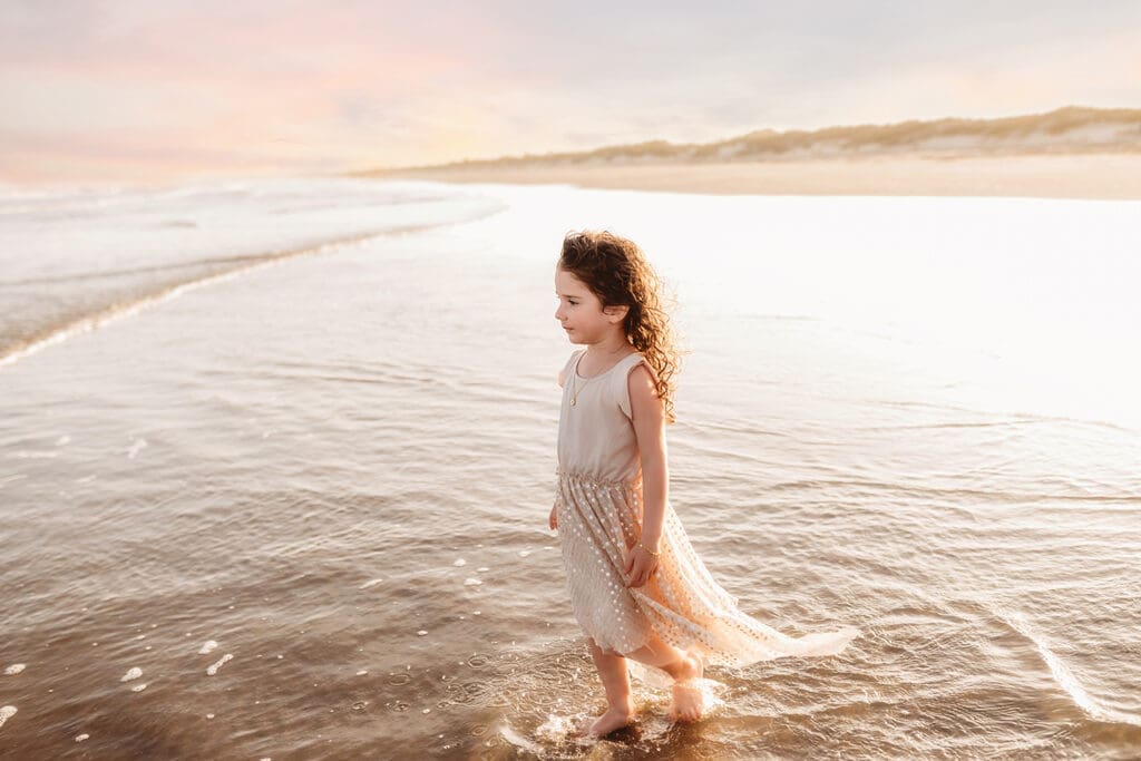 Little girl gazes out at the ocean during Family Portraits on Kiawah Island with Holy City Family Photography.