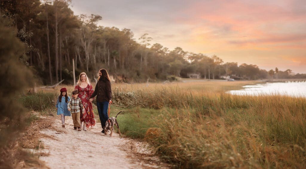Family walks along the harbor together during Fall Mini Session in Charleston, SC after learning about Charleston Mini Sessions from Holy City Family Photography. 