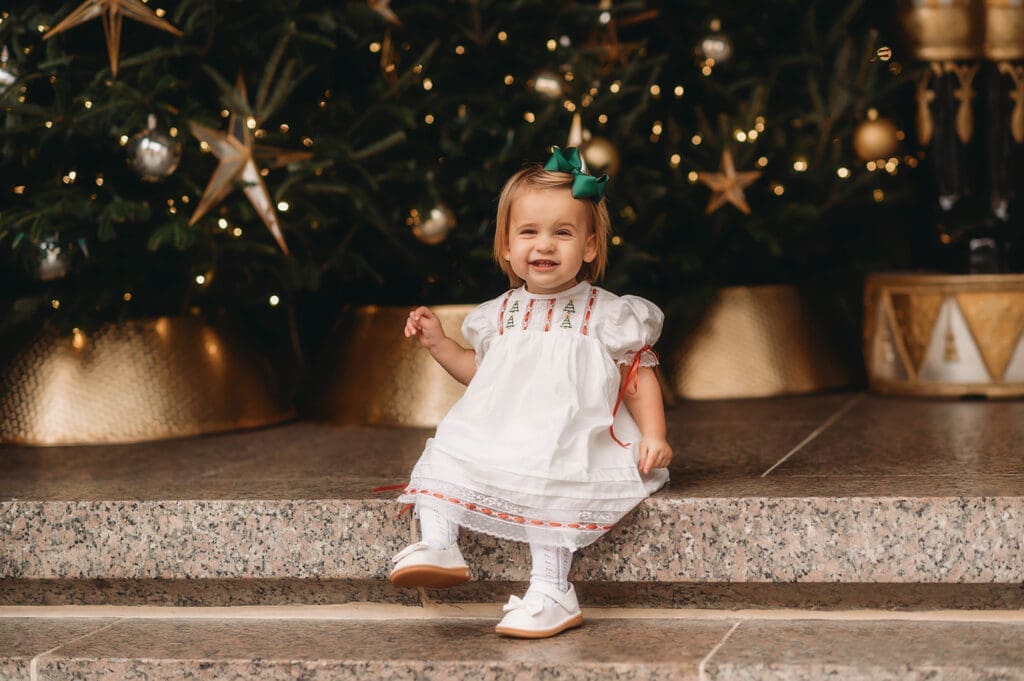 Baby laughs at the camera for Holiday Mini Sessions in Downtown Charleston, SC. 