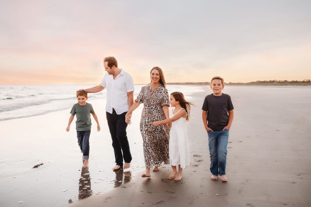 Family walks together along the beach during Family Photos on Kiawah Island with Holy City Family Photography. 