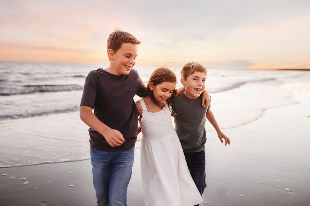 Children play together along the beach during Family Photos on Kiawah Island with Holy City Family Photography. 