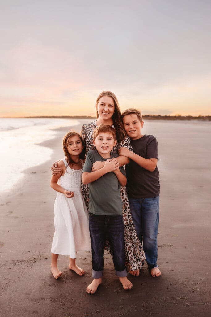 Mother embraces her children during Family Portrait Session on Kiawah Island with Holy City Family Photography. 