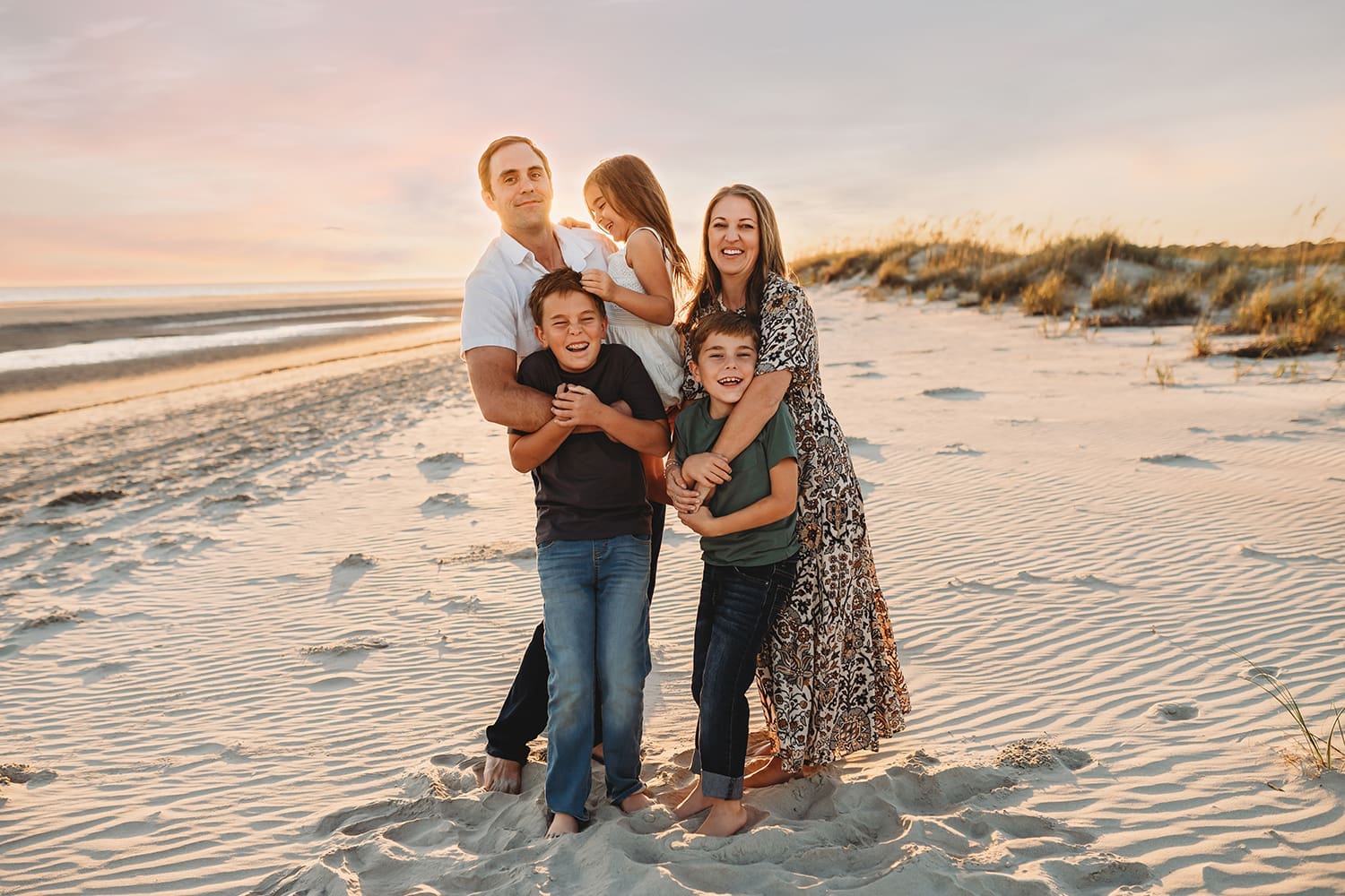 Family poses together during Family Portraits on Kiawah Island after reading about the Best Restaurants on Kiawah Island with Kids on Holy City Families Blog!