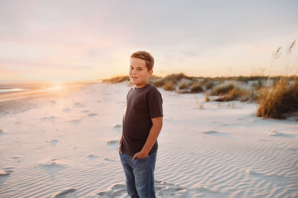 Young boy gazes at the camera, during Family Portraits on Kiawah Island with Holy City Family Photography. 