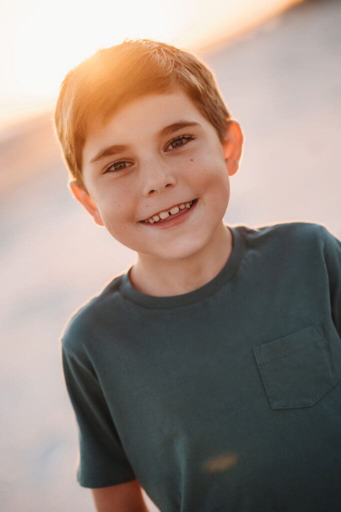 Little boy smiles at the camera during Family Photo Session on Kiawah Island after reading about the Best Restaurants on Kiawah Island with Kids on Holy City Families Blog! 