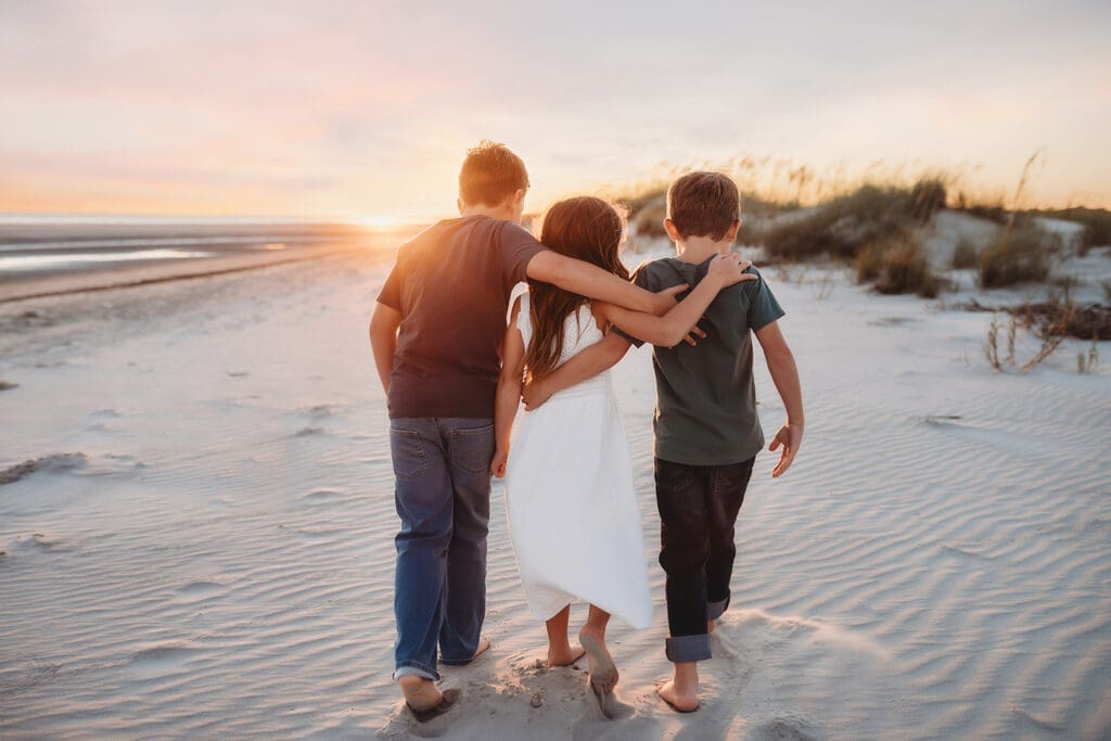 Children walk along the beach together during Family Photoshoot on Kiawah Island after reading about the Best Restaurants on Kiawah Island with Kids on Holy City Families Blog! 
